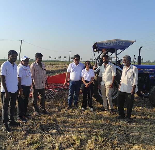 Kisani advisory team walking a paddy field with farmers